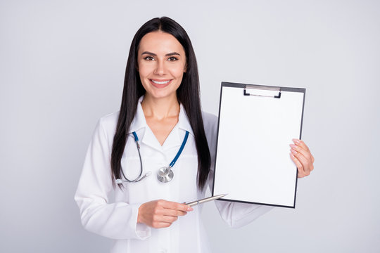 Photo of beautiful professional doc lady showing patient place for signing contract clinic insurance agreement wear stethoscope white lab coat isolated grey color background