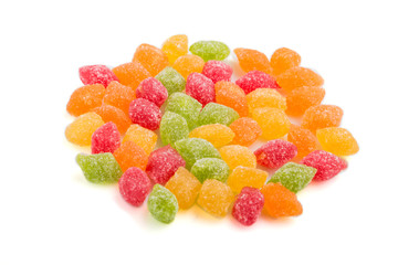 Pile of multicolored candies isolated on white background. close up, side view.