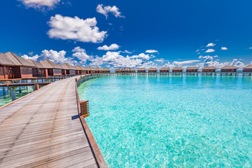 Panoramic landscape of Maldives beach. Tropical panorama, luxury water villa resort with wooden pier or jetty. Luxury travel destination background for summer holiday and vacation concept.