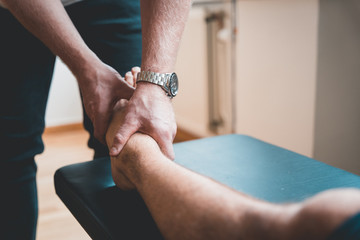 Physiotherapist treating patient for various physical ailments