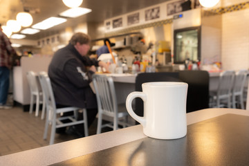Fototapeta na wymiar closeup of a cup of coffee at cafe