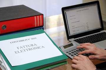 Milan , Italy january 5,2018 ( electronic )  e - invocing - secretary makes an electronic bill with...