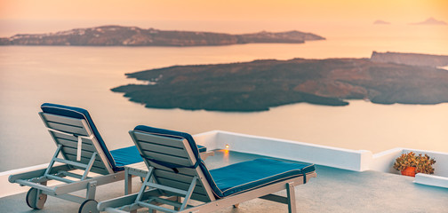 Beautiful and famous sunset on Santorini island, Greece. Beautiful terrace with sea view. Travel and vacation