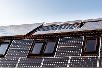 Fototapeta premium House with solar panels and solar panels for water heating on roof - regenerative energy system electricity generation