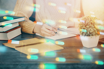 Double exposure of writing hands on background with data solution hologram on front. Technology concept. Close up