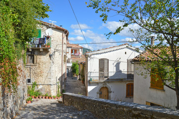 Fototapeta na wymiar A narrow street between the houses of Morcone, a medieval village in the Campania region in Italy