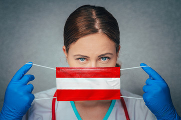 Coronavirus in Austria Female Doctor Portrait hold protect Face surgical medical mask with Austria...