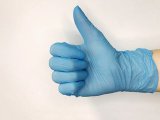Hand in blue glove isolated on white with thumb up