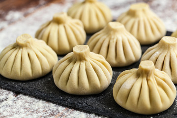 raw dumplings khinkali ravioli in flour
