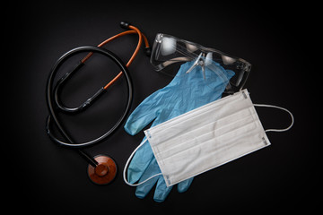 Protective medical equipment during a virus epidemic, Surgical mask, goggles, stethoscope and medical gloves