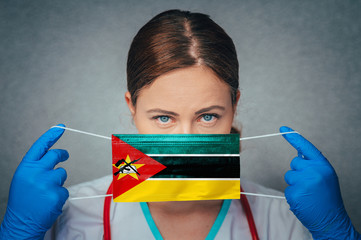Coronavirus in Mozambique Female Doctor Portrait hold protect Face surgical medical mask with...