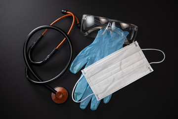 Protective medical equipment during a virus epidemic, Surgical mask, goggles, stethoscope and medical gloves