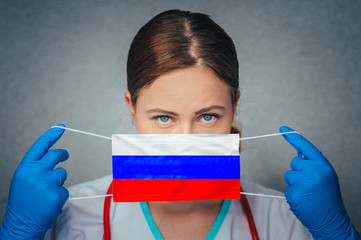 Coronavirus in Russia Female Doctor Portrait hold protect Face surgical medical mask with Russia...