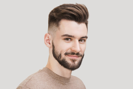 Closeup Portrait Of Handsome Smiling Young Man. Laughing Joyful Cheerful Men Studio Shot. Isolated On Gray Background	