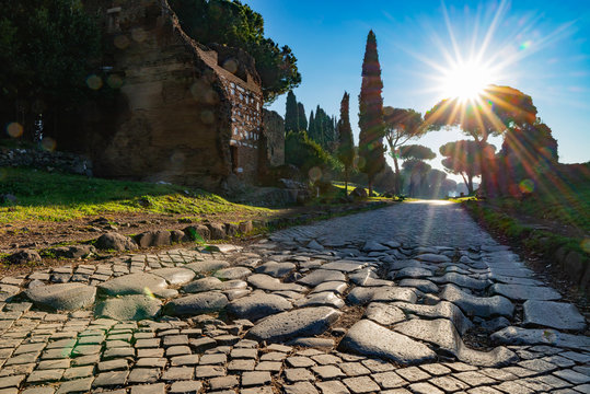 A stretch of the Via Appia, one of the most important streets of the Roman Empire photographed at first light in the morning. This road connected Rome to Brindisi, an important port in ancient Italy.