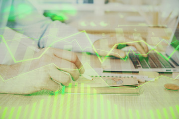 Multi exposure of financial graph with man works in office on background. Concept of analysis.