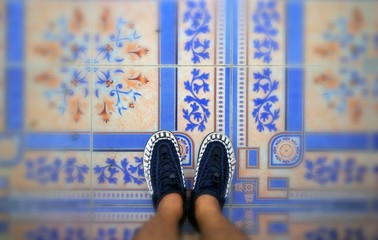 Blue white shoes walking on the tiles top view