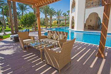 Table by a swimming pool of luxury hotel resort room