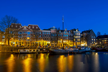 Obraz premium City scenic from Amsterdam with the in the Netherlands at sunset