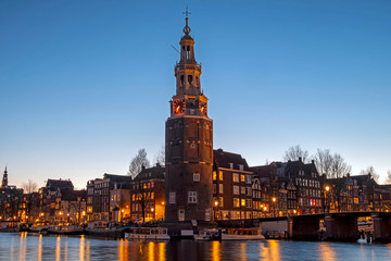 Naklejka premium City scenic from Amsterdam with the Montelbaan Tower in the Netherlands at sunset