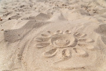 the sun on the sand is drawn by hand