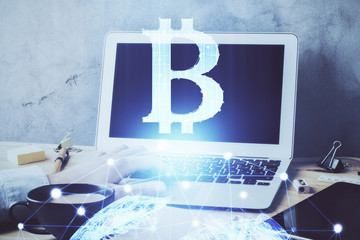 Crypto currency theme hologram with businessman working on computer on background. Concept of...