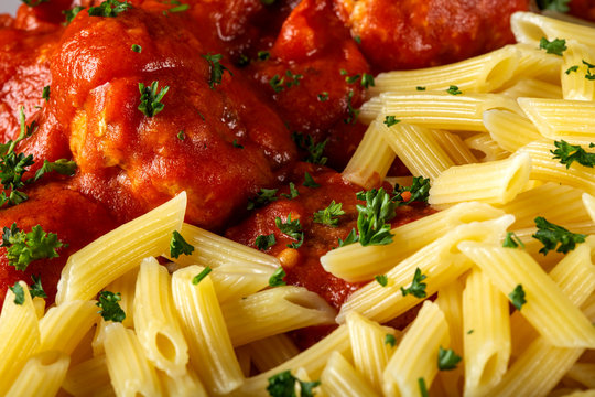 Meatballs in tomato sauce with small penne pasta