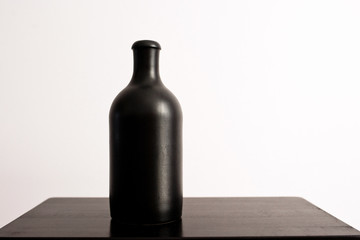 Black clay bottle on a white background