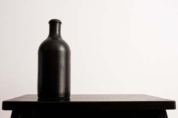 Black clay bottle on a white background