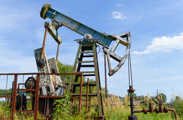 Fototapeta na wymiar Industrial oil pump jack working and pumping crude oil in Boryslav