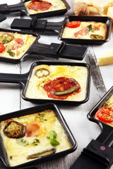 Delicious traditional Swiss melted raclette cheese on diced boiled or baked potato.