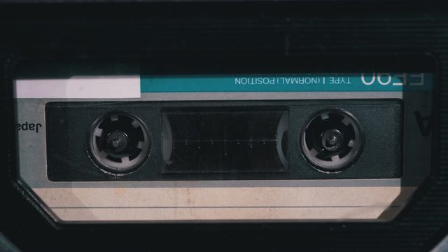 Audio Cassette in the Tape Recorder Playing and Rotates