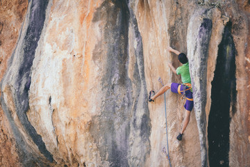 Man climbs a rock. 