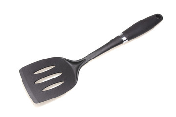 Plastic black spatula for a frying pan isolated on white background.