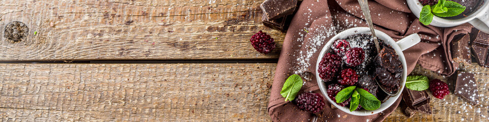 Homemade chocolate mug cake with blackberry. Breakfast easy snack recipe, chocolate non dairy cake...