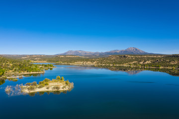 Aerial view of landscape american nature. Blue sky and lake,  mountains reflection in water. Recapture reservoir in Utah state, USA