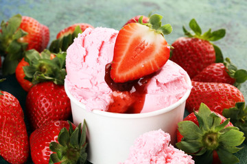 Strawberry ice cream scoop with fresh strawberries