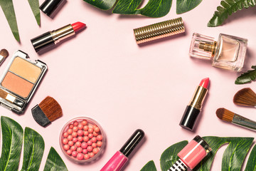 Makeup professional cosmetics on pink background.