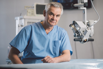 Portrait of serious surgeon that posing on camera