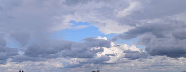 Fototapeta premium Cloudy sky, great horizons. Panoramic photography, atmospheric phenomenon, the formation of water vapor in natural conditions.