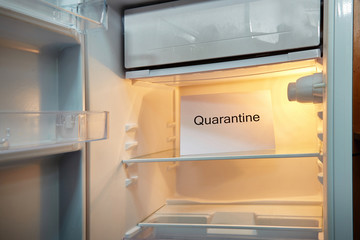 The refrigerator is empty without food, a plate with the inscription Quarantine