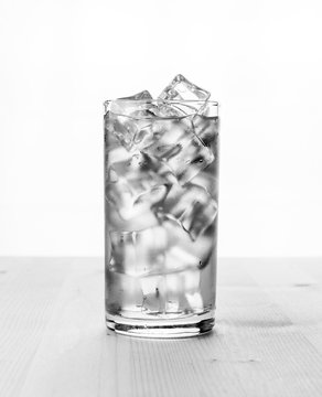 Glass of cold water with ice cubes. .