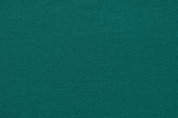 Green-blue background with a textured surface, fabric.