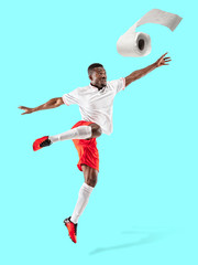 Fototapeta premium Professional sportsman caught toiletpaper in motion. Reaching target, sport and healthy lifestyle, high demand for essential goods in crisis concept. Competition, championship. Buy enough to be winner