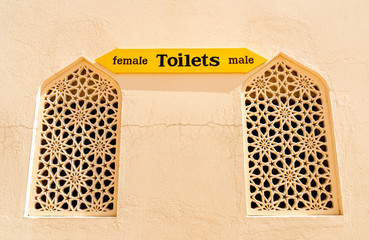 Toilet Sign for entrance to male and female on the wall.