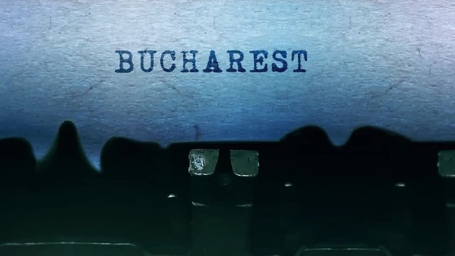 Burcharest Word closeup Being Typing and Centered on a Sheet of paper on old vintage Typewriter mechanical 4k Footage Background Animation.