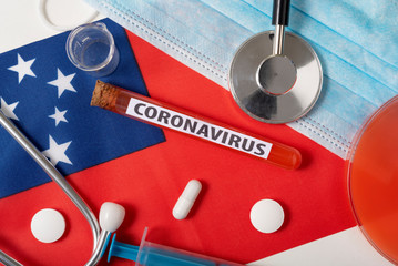 Coronavirus, nCoV concept. Top view protective breathing mask, stethoscope, syringe, tablets on the...