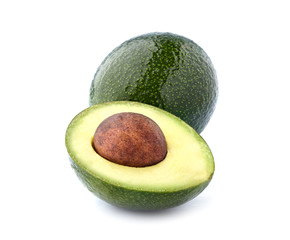 Whole green avocado  with half isolated on white background