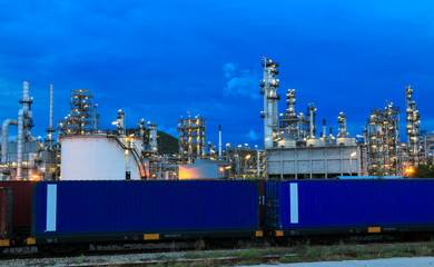 Fototapeta premium The oil refinery industry, petroleum, petrochemical plants full of technology. And the blue background, orange lights