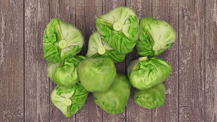A lot of cabbage on the wooden background top view. Healthy diet food. 3D illustration